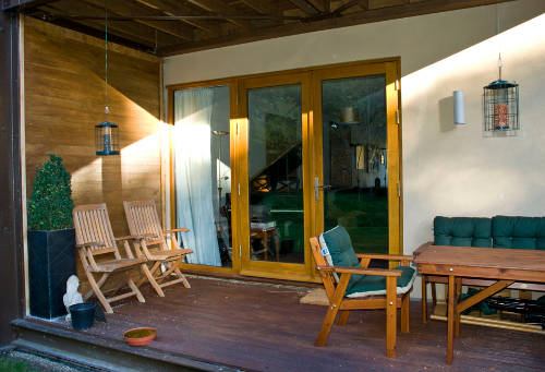 sitting area opening onto woodland